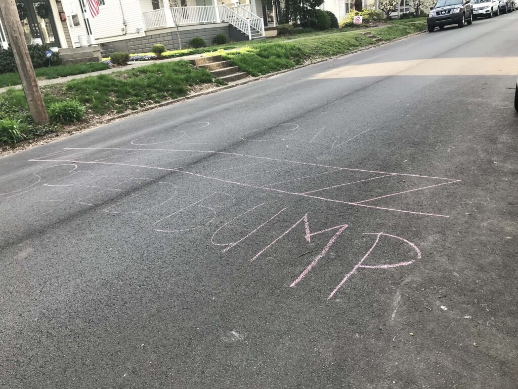 asphalt with speed bumpt written on it in chalk
